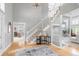 Bright foyer with hardwood floors, an elegant staircase, and an open view into the living spaces at 920 Shady Oak Ln, Castle Pines, CO 80108