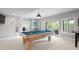 This game room offers a large pool table and access to outdoor relaxation and dining at 920 Shady Oak Ln, Castle Pines, CO 80108