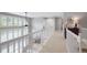 Second-floor hallway features open railing, neutral carpet, and ample natural light from the bright windows at 920 Shady Oak Ln, Castle Pines, CO 80108