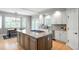 Modern kitchen with a large island, granite countertops, stainless steel appliances, and ample cabinet space at 920 Shady Oak Ln, Castle Pines, CO 80108