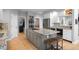 This kitchen features a large island with granite countertops, stainless steel appliances, and a breakfast bar with seating at 920 Shady Oak Ln, Castle Pines, CO 80108