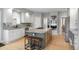 Spacious kitchen features granite countertops, stainless steel appliances, tile backsplash, and a center island with seating at 920 Shady Oak Ln, Castle Pines, CO 80108