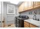 Convenient laundry room with updated appliances, ample cabinet space, and a utility sink at 920 Shady Oak Ln, Castle Pines, CO 80108