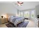 Vaulted main bedroom with large windows, neutral carpet, ceiling fan, and a cozy sitting area at 920 Shady Oak Ln, Castle Pines, CO 80108