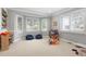 Bright playroom with bay windows, comfortable beanbag chairs, and carpet flooring at 920 Shady Oak Ln, Castle Pines, CO 80108