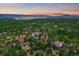 Panoramic aerial view of modern home nestled in lush landscape with mountain views at 8045 Eagle Rd, Larkspur, CO 80118