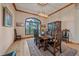 Formal dining room featuring hardwood floors, wood trim, and a mountain view through a large window at 8045 Eagle Rd, Larkspur, CO 80118