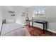 Cozy bedroom with striped bedding, wood floors, and a writing desk at 3433 E Costilla Ave, Centennial, CO 80122