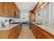 Bright kitchen with wood cabinets, stainless steel appliances, and tile backsplash at 3433 E Costilla Ave, Centennial, CO 80122