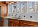 Modern kitchen sink with wood cabinets and updated faucet at 3433 E Costilla Ave, Centennial, CO 80122