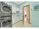 Convenient laundry room with stacked washer/dryer and ample counter space at 4337 W Hinsdale Ave, Littleton, CO 80128