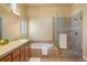 Bright bathroom features a separate shower, bathtub, double vanity, and tile flooring at 3441 Medallion Rd, Castle Rock, CO 80104