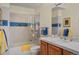 Bright bathroom features a shower over the bathtub and neutral tile flooring at 3441 Medallion Rd, Castle Rock, CO 80104