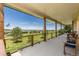 Expansive covered porch with seating and views of rolling hills at 3441 Medallion Rd, Castle Rock, CO 80104