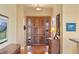 Welcoming foyer with a wood door, a side window, hardwood floors, and a wood accent table at 3441 Medallion Rd, Castle Rock, CO 80104