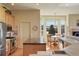 An open kitchen with stainless steel appliances, a breakfast nook with large bay windows, and tile countertops at 3441 Medallion Rd, Castle Rock, CO 80104