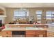 Sun-drenched kitchen features mountain views, breakfast bar, stainless steel appliances, and light wood cabinets at 3441 Medallion Rd, Castle Rock, CO 80104