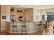 Kitchen with a breakfast bar, light wood cabinets, stainless steel appliances, and a breakfast nook at 3441 Medallion Rd, Castle Rock, CO 80104