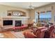 Cozy living room with a fireplace, mantel, comfortable seating, and view of the mountains at 3441 Medallion Rd, Castle Rock, CO 80104