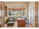 Bright home office with built-in shelving, desk, and bay window providing natural light and scenic views at 3441 Medallion Rd, Castle Rock, CO 80104