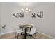 This dining area features a modern chandelier and contemporary artwork for an elegant aesthetic at 10437 W Hampden Ave # 104, Lakewood, CO 80227