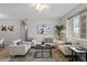 Living room featuring neutral decor, plush rug, and abundant natural light at 10437 W Hampden Ave # 104, Lakewood, CO 80227