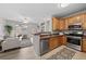 Inviting living space with wood cabinets and stainless steel appliances in kitchen at 10437 W Hampden Ave # 104, Lakewood, CO 80227