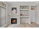 Cozy living space with a fireplace and built-in shelving for storage at 10437 W Hampden Ave # 104, Lakewood, CO 80227