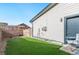 Artificial turf backyard with a side gate and exterior access at 5731 Boston Ct, Denver, CO 80238