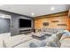 Basement recreation area with sectional sofa and a large TV at 5731 Boston Ct, Denver, CO 80238