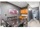 Basement kitchenette with wood cabinets and a dining table for four at 5731 Boston Ct, Denver, CO 80238