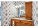 Modern bathroom with single sink, granite countertop, and wood cabinets at 5731 Boston Ct, Denver, CO 80238