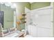 Bathroom with single sink, tub, and wooden shelves at 5731 Boston Ct, Denver, CO 80238