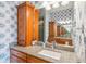 Bathroom with double sinks, granite countertop, and wood cabinets at 5731 Boston Ct, Denver, CO 80238