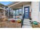 Inviting front porch with blue door and small landscaping at 5731 Boston Ct, Denver, CO 80238