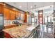 Open concept kitchen with granite island and stainless steel appliances at 5731 Boston Ct, Denver, CO 80238