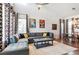 Spacious living room featuring a sectional sofa and large windows at 5731 Boston Ct, Denver, CO 80238