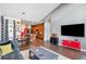 Open concept living area with hardwood floors and a red accent wall at 5731 Boston Ct, Denver, CO 80238