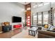 Open living space with sectional sofa and modern wood wall at 5731 Boston Ct, Denver, CO 80238