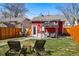 Expansive backyard with multiple seating areas including a patio set and a covered lounge space at 4452 Zenobia St, Denver, CO 80212