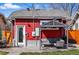 Charming backyard featuring a covered patio area with outdoor seating and a vibrant red exterior at 4452 Zenobia St, Denver, CO 80212