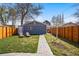 Secluded backyard featuring a well-maintained lawn, lounging chairs, and a stone pathway at 4452 Zenobia St, Denver, CO 80212