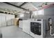Functional basement featuring laundry machines, storage cabinets and exposed ceiling at 4452 Zenobia St, Denver, CO 80212