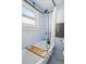 Bathroom featuring a clawfoot tub with a vintage-style shower and a wooden bath caddy at 4452 Zenobia St, Denver, CO 80212