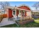 Inviting front porch with two white Adirondack chairs and brick planter under a charming overhang at 4452 Zenobia St, Denver, CO 80212