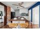 Charming kitchen featuring a wood island, white cabinets, and a brick accent wall at 4452 Zenobia St, Denver, CO 80212