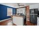 Bright kitchen featuring stainless steel appliances, white cabinets, and access to the living room at 4452 Zenobia St, Denver, CO 80212