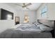 Bedroom featuring a large bed, neutral tones, a TV, and natural light from two windows at 4452 Zenobia St, Denver, CO 80212