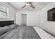 Bedroom featuring a large bed, neutral tones, a walk-in closet, and natural light from a stained glass window at 4452 Zenobia St, Denver, CO 80212