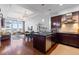 Spacious kitchen adjacent to the dining and living area, featuring dark wood cabinets and stainless steel appliances at 5455 Landmark Pl # 903, Greenwood Village, CO 80111